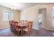 Dining room with a large wooden table and eight chairs near a window and an adjacent room at 17855 Lake Side Dr, Monument, CO 80132