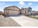 Charming single-story home with a concrete driveway and a well maintained front yard and stone accents at 17855 Lake Side Dr, Monument, CO 80132