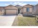 Charming single-story home featuring stone accents, a two-car garage, and well-manicured landscaping at 17855 Lake Side Dr, Monument, CO 80132