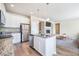 Open kitchen with stainless appliances, granite counters, island and breakfast bar connects to living area at 17855 Lake Side Dr, Monument, CO 80132