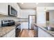 Bright kitchen features granite countertops, stainless steel appliances, and crisp white cabinetry at 17855 Lake Side Dr, Monument, CO 80132