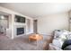 A spacious living room offers neutral colors, a cozy fireplace, and lots of natural light at 17855 Lake Side Dr, Monument, CO 80132