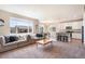 Large windows fill this open living room and kitchen space with sunlight at 17855 Lake Side Dr, Monument, CO 80132