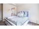 Bedroom boasts a stylish platform bed with storage and a partial view of the en-suite bathroom at 17855 Lake Side Dr, Monument, CO 80132