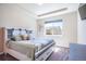 Bedroom features a white platform bed with built-in storage, a large window, and neutral-toned walls at 17855 Lake Side Dr, Monument, CO 80132