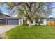 Charming home featuring lush green lawn and mature trees in a well-maintained front yard at 720 Independence Dr, Longmont, CO 80504