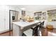 Modern kitchen featuring stainless steel appliances, white cabinetry, and a center island with seating at 720 Independence Dr, Longmont, CO 80504