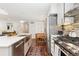 Updated kitchen featuring stainless steel appliances, white cabinets, and a modern aesthetic at 720 Independence Dr, Longmont, CO 80504