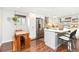 Updated kitchen with stainless steel appliances, white cabinets, and a breakfast nook at 720 Independence Dr, Longmont, CO 80504