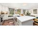 Bright kitchen featuring a large island, modern appliances, and a cozy window seat at 720 Independence Dr, Longmont, CO 80504