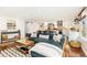 Bright living room open to the kitchen, featuring stylish decor and hardwood flooring at 720 Independence Dr, Longmont, CO 80504