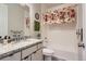 Well-maintained bathroom with vanity, granite countertop, and tub with floral shower curtain at 6805 Zebra Grass Ln, Parker, CO 80138