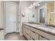 Bright bathroom featuring double sinks with granite counters and modern fixtures, adjacent to a glass-enclosed shower at 6805 Zebra Grass Ln, Parker, CO 80138