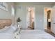Bright bedroom with wood-look flooring and bathroom entrance at 6805 Zebra Grass Ln, Parker, CO 80138