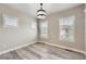 Well-lit bedroom with hardwood floors and ample natural light from three windows at 6805 Zebra Grass Ln, Parker, CO 80138
