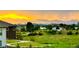 Beautiful sunset view overlooking grassy green space with city and mountain views in the distance at 6805 Zebra Grass Ln, Parker, CO 80138