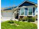 Charming home featuring a well-manicured lawn, solar panels, window boxes, and a two-car garage at 6805 Zebra Grass Ln, Parker, CO 80138