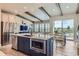Open kitchen with island, stainless appliances, and dining area with view at 6805 Zebra Grass Ln, Parker, CO 80138
