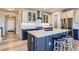 Stylish kitchen with a large island, stainless steel appliances, and updated fixtures at 6805 Zebra Grass Ln, Parker, CO 80138
