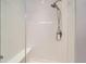 Modern walk-in shower with white tiled walls and a shower seat at 6805 Zebra Grass Ln, Parker, CO 80138