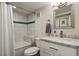 Bathroom featuring modern vanity with marble countertop and bathtub with tiled wall and shower at 916 Adams St, Denver, CO 80206