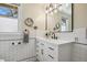 Bright bathroom with retro styling, a vanity, a sink, and a modern mirror at 916 Adams St, Denver, CO 80206