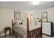 Charming bedroom with wood bed frame, plant decor, dresser, and large framed artwork at 916 Adams St, Denver, CO 80206