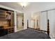 Cozy bedroom featuring a four-poster bed, guitar, and wood desk with drawers and storage at 916 Adams St, Denver, CO 80206