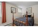 Bedroom featuring a wooden bed frame and a window with orange curtains at 916 Adams St, Denver, CO 80206