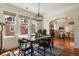 Elegant dining room featuring hardwood floors, a modern light fixture, and large windows at 916 Adams St, Denver, CO 80206