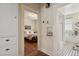 Hallway view to bedroom and bathroom with wooden floors and white walls at 916 Adams St, Denver, CO 80206