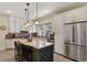 Charming kitchen with a kitchen island, stainless steel refrigerator, and beautiful granite countertops at 916 Adams St, Denver, CO 80206
