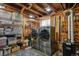 Laundry room features new washer, dryer, storage racks and exposed beams at 916 Adams St, Denver, CO 80206