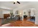 Open-concept living room with hardwood floors, a gray couch, and seamless flow into the dining area at 916 Adams St, Denver, CO 80206