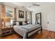 A spacious bedroom with hardwood floors, lots of natural light, and a large mirror at 916 Adams St, Denver, CO 80206