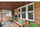 Charming covered porch featuring comfortable seating, a wooden bench, and beautiful plants at 916 Adams St, Denver, CO 80206