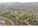 Aerial shot showcasing a property nestled in a dense forest with a red boundary line at 2654 Sinton Rd, Evergreen, CO 80439