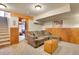 Relaxing basement space with a comfortable sectional sofa and wood-paneled accent wall at 2654 Sinton Rd, Evergreen, CO 80439