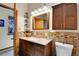 Well-lit bathroom boasts granite counters, wood-look tiling, and an open doorway at 2654 Sinton Rd, Evergreen, CO 80439