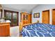 Bedroom featuring a blue comforter, wooden cabinet and french doors to an outdoor balcony at 2654 Sinton Rd, Evergreen, CO 80439