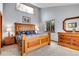 Spacious bedroom featuring hardwood furnishings including a bed, dresser, and nightstands at 2654 Sinton Rd, Evergreen, CO 80439