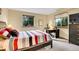 Cozy bedroom with a striped bedspread, desk area by the window, and ample natural light at 2654 Sinton Rd, Evergreen, CO 80439