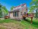 Exterior view of a multi-story home with wood siding, a deck, and a lush green lawn at 2654 Sinton Rd, Evergreen, CO 80439