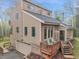 Exterior view of a charming home with a deck, stone accents, a well-manicured lawn and steps at 2654 Sinton Rd, Evergreen, CO 80439