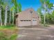 Detached garage with multiple doors, offering ample space for vehicles and storage at 2654 Sinton Rd, Evergreen, CO 80439