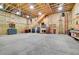Spacious garage interior with exposed framing, a built-in work area, and concrete floors at 2654 Sinton Rd, Evergreen, CO 80439