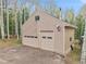 Detached two-car garage with gable roof, surrounded by trees, and ample space for vehicles and storage at 2654 Sinton Rd, Evergreen, CO 80439
