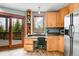 Kitchen with adjacent office and sliding door leading to patio with wooded view at 2654 Sinton Rd, Evergreen, CO 80439