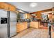 Modern kitchen with stainless steel fridge, sleek wood cabinets, granite countertops and an open design for easy entertaining at 2654 Sinton Rd, Evergreen, CO 80439