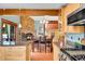 Open concept kitchen with wood cabinets, granite countertops, and views into the dining room at 2654 Sinton Rd, Evergreen, CO 80439